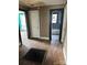 Hallway featuring wood floors, multiple doorways, and vintage details awaiting restoration at 839 S Chester St, Gastonia, NC 28052