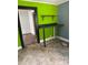 An unfinished kitchen with green walls and a countertop workspace, offering renovation potential at 839 S Chester St, Gastonia, NC 28052