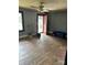 Empty living room with worn hardwood floors, gray walls, and a red front door needing some care at 839 S Chester St, Gastonia, NC 28052