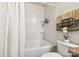 Clean bathroom featuring a shower-tub combo with tiled surround, neutral walls and decor at 925 Skywatch Ln, Monroe, NC 28112
