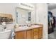Well-lit bathroom with double sinks, neutral countertops, and essential amenities at 925 Skywatch Ln, Monroe, NC 28112