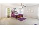 Comfortable bedroom featuring plush carpeting, a ceiling fan, and purple accent decor at 925 Skywatch Ln, Monroe, NC 28112