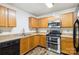 Well-equipped kitchen with stainless steel appliances, wooden cabinetry and hardwood flooring at 925 Skywatch Ln, Monroe, NC 28112