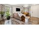 Spacious living room features stylish sofas, hardwood floors, a ceiling fan and large windows with curtains at 925 Skywatch Ln, Monroe, NC 28112
