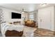 Cozy living room has a ceiling fan and is furnished with brown leather sofa and attractive window coverings at 925 Skywatch Ln, Monroe, NC 28112