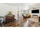 Open concept living room has hardwood floors, modern furnishings and plenty of natural light at 925 Skywatch Ln, Monroe, NC 28112
