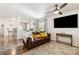Inviting living room features a ceiling fan, decorative rug and a brown leather sofa with accent pillows at 925 Skywatch Ln, Monroe, NC 28112