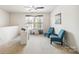 Bright loft area with desk, blue chairs, and natural light, creating an inviting space for work or relaxation at 925 Skywatch Ln, Monroe, NC 28112