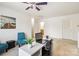 View of the loft area with a white desk, blue chairs, and ample natural light from the window at 925 Skywatch Ln, Monroe, NC 28112