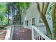 A spacious backyard deck with white railings and stained wood floors at 9513 Saddle Run Trl, Charlotte, NC 28269