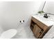 Bathroom features a modern vanity with white countertop and wood finish, plus updated fixtures and marble tile flooring at 9513 Saddle Run Trl, Charlotte, NC 28269