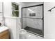 Modern bathroom with marble tile, glass shower, and black fixtures at 9513 Saddle Run Trl, Charlotte, NC 28269