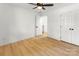 Bedroom with ceiling fan, light wood floors, and closet at 9513 Saddle Run Trl, Charlotte, NC 28269