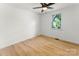 Cozy bedroom with light wood floors, ceiling fan, and a bright window at 9513 Saddle Run Trl, Charlotte, NC 28269