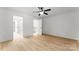 Large empty bedroom featuring vinyl floors, ceiling fan, white walls and trim at 9513 Saddle Run Trl, Charlotte, NC 28269