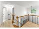 Upstairs hallway with wood floors and staircase at 9513 Saddle Run Trl, Charlotte, NC 28269