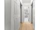 Hallway features a view of a bathroom with white marble tile and glass shower at 9513 Saddle Run Trl, Charlotte, NC 28269