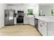 Bright, remodeled kitchen featuring stainless steel appliances, white cabinetry, and modern countertops at 9513 Saddle Run Trl, Charlotte, NC 28269