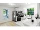 Bright kitchen featuring stainless steel appliances, white cabinets, countertops, and a large window at 9513 Saddle Run Trl, Charlotte, NC 28269