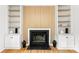 Living room boasting a fireplace with built-in shelving and hardwood floors at 9513 Saddle Run Trl, Charlotte, NC 28269