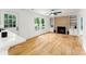 Bright living room features a fireplace with built-in shelving, hardwood floors, and lots of natural light at 9513 Saddle Run Trl, Charlotte, NC 28269