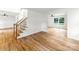 Living area with hardwood floors, staircase, and a view into the adjacent room, offering a spacious feel at 9513 Saddle Run Trl, Charlotte, NC 28269