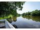 Scenic view of the community pond from a wooden deck at 9513 Saddle Run Trl, Charlotte, NC 28269