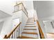 Staircase has wood steps and banister with black iron spindles leading to the upper level at 9513 Saddle Run Trl, Charlotte, NC 28269
