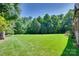 Large, well-maintained backyard featuring a lush green lawn and mature trees at 103 3Rd Sw St, Catawba, NC 28609