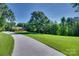 Long driveway leading to the brick home, surrounded by a beautifully maintained lawn and mature trees at 103 3Rd Sw St, Catawba, NC 28609