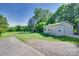 Exterior of a detached garage with a concrete driveway and grassy yard with mature trees at 103 3Rd Sw St, Catawba, NC 28609