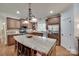 Gourmet kitchen featuring granite countertops, stainless steel appliances, custom cabinets, and a large center island with seating at 103 3Rd Sw St, Catawba, NC 28609