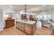 Open-concept kitchen with a large island, custom cabinetry, and hardwood floors, seamlessly connecting to the living and dining areas at 103 3Rd Sw St, Catawba, NC 28609