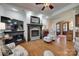 Bright living room features a fireplace, wood floors, large tv, and an arched doorway to the foyer at 103 3Rd Sw St, Catawba, NC 28609
