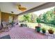 Covered brick patio featuring rocking chairs, ceiling fan, and beautiful view of backyard at 103 3Rd Sw St, Catawba, NC 28609