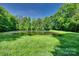 Peaceful pond surrounded by lush greenery, creating a serene and natural environment at 103 3Rd Sw St, Catawba, NC 28609