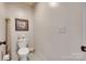 Powder room with white toilet, decorative painting, and decorative carved column at 103 3Rd Sw St, Catawba, NC 28609