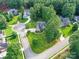 Aerial view of manicured lawns and mature trees surrounding beautiful residential homes at 105 Beech Bluff Dr, Mount Holly, NC 28120