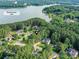 Stunning aerial view of lakeside homes nestled among lush greenery with lake access at 105 Beech Bluff Dr, Mount Holly, NC 28120