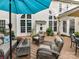 Spacious back deck with cozy seating, a dining table, an umbrella, and a view of the home's architectural details at 105 Beech Bluff Dr, Mount Holly, NC 28120