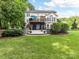 Expansive backyard view featuring a deck, patio, lush lawn, and mature trees for outdoor enjoyment and relaxation at 105 Beech Bluff Dr, Mount Holly, NC 28120
