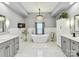 Bright bathroom with a soaking tub, elegant chandelier, and double sink vanity at 105 Beech Bluff Dr, Mount Holly, NC 28120