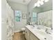 Bathroom featuring double sinks, tile flooring, and neutral tones at 105 Beech Bluff Dr, Mount Holly, NC 28120