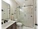 Modern bathroom featuring a glass-enclosed shower with tile, a vanity sink, and contemporary fixtures at 105 Beech Bluff Dr, Mount Holly, NC 28120