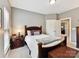 Cozy bedroom featuring a wood-framed bed, carpeted floors, and a side table with reading lamp at 105 Beech Bluff Dr, Mount Holly, NC 28120