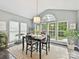 Bright breakfast nook with large windows offering natural light and views of the backyard at 105 Beech Bluff Dr, Mount Holly, NC 28120