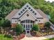Striking clubhouse featuring stone accents and a peaked roofline with decorative windows at 105 Beech Bluff Dr, Mount Holly, NC 28120