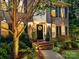 Inviting front porch featuring a wreath, sconces, and well-manicured landscaping at 105 Beech Bluff Dr, Mount Holly, NC 28120