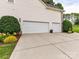 Spacious three-car garage with ample parking and driveway space at 105 Beech Bluff Dr, Mount Holly, NC 28120