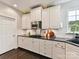 Galley kitchen with stainless steel appliances, granite countertops, and white cabinets at 105 Beech Bluff Dr, Mount Holly, NC 28120